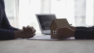 Discussing real estate business ideas with home designs Signing home sales and insurance contracts with real estate agents Signing a contract to know the conditions for buying-selling houses and real estate