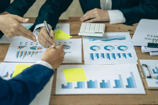 Investment finance concept, group of young businessmen pointing to graph Business advisory meetings and strategic brainstorming sessions, analysis with financial and market data. new business project