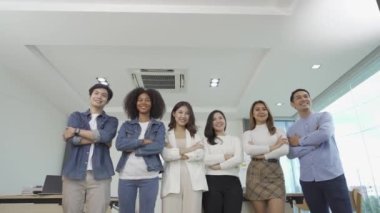 Business team standing confidently with arms crossed. Raised. Video shot of business team proudly standing with arms crossed after accomplishing business achievement goal.