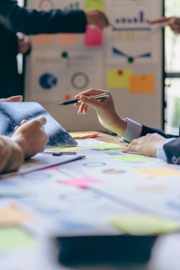 Group of business people writing with ballpoint pen on document with close up graph Businessman working and pointing to financial diagram and analyzing document on office table