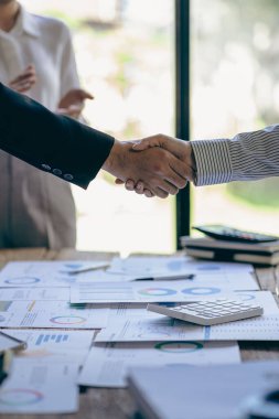 Successful negotiation and handshake concept Two businessmen shake hands with partners to celebrate cooperation and teamwork, mergers and acquisitions. Successful negotiations, business deal concept