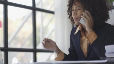 Black and white businesswoman talking on the phone and discussing documents, sales representative talking on the phone, consulting customer closely office work smiling woman