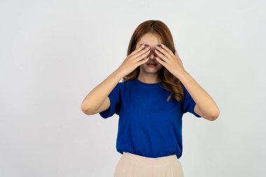 Tired, exhausted, sad, has a headache Young Asian woman in blue t-shirt. Close eyes. Rub hands on nose isolated on white background. concept of health care