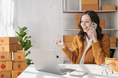 with an excited smile The woman received the name order on her smartphone. Ready to send parcels online, business ideas, sme, online sales