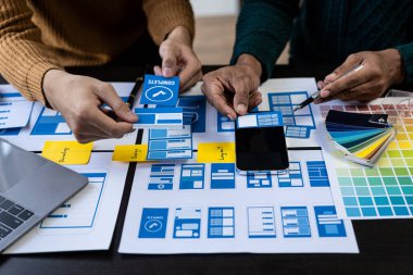 Asian young people working together Mobile Application Software Design Project Brainstorming, internet technology, smartphone web designer, creative teamwork concept.