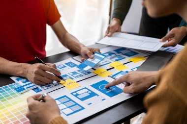 Asian young people working together Mobile Application Software Design Project Brainstorming, internet technology, smartphone web designer, creative teamwork concept.