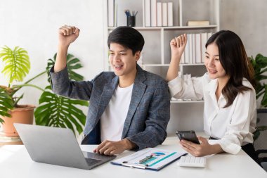 Group of young businessmen in suits, Asian men and women are focused and excited about work. and cheering team members with happy hands up web banner, financial accounting business concept