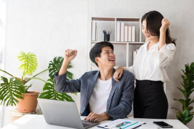 Group of young businessmen in suits, Asian men and women are focused and excited about work. and cheering team members with happy hands up web banner, financial accounting business concept