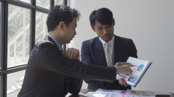 Two Businessmen Suits Discussing Project Paper Graphs Charts Pointing Financial — Stock video