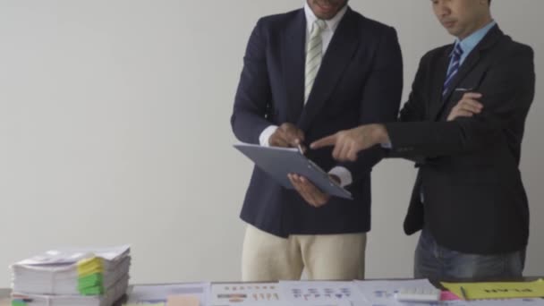 Two Businessmen Suits Discussing Project Paper Graphs Charts Pointing Financial — Stockvideo