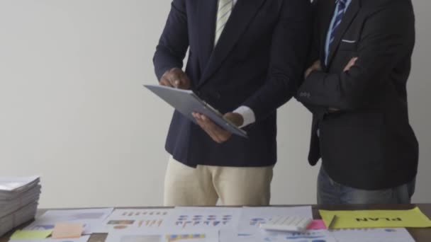 Two Businessmen Suits Discussing Project Paper Graphs Charts Pointing Financial — Vídeo de Stock