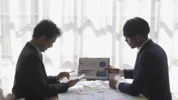 Two Businessmen Suits Discussing Project Paper Graphs Charts Pointing Financial — Stockvideo