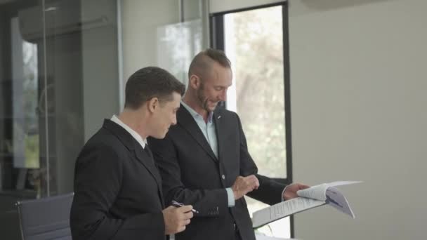 Two Excited Top Financial Managers Holding Laptop Looking Documents Celebrating — Stockvideo