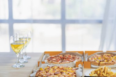 Group of employees eating Italian pizza Hand picked pizza in a lunch or dinner shop. Tasty seafood gravy sauce. Traditional Italian fast food on wooden table with drinking wine.