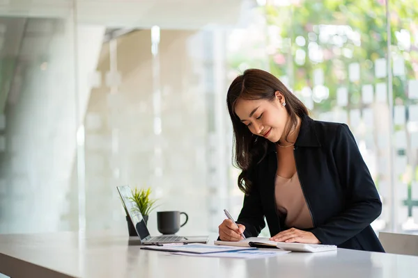 stock image Asian woman working online and planning financial data with laptop computer and financial documents work from home Businesswoman and financial planner