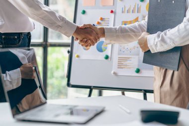 İş adamı ve iş arkadaşı el ele tutuşarak finans, bankacılık ve iş yatırımları, finans, vergi, kredi kavramını masaya yatırdılar.