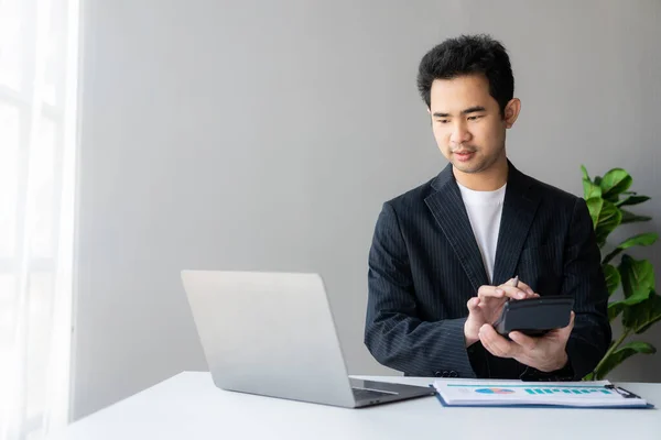 stock image Young asian businessman planning analyzing financial data charts and graphs and successful business laptop