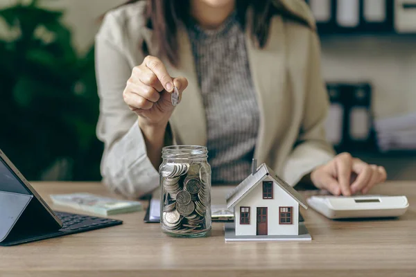 住宅事業と金融のための金利木製のテーブルの上の家 コインや貯金箱の家モデルのためのお金の節約の概念 — ストック写真