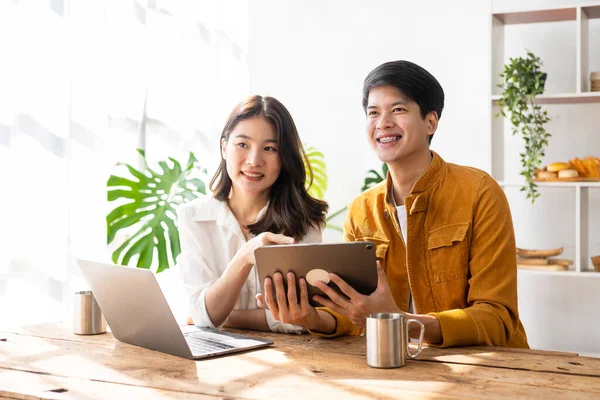 Stock image Business couple and successful business asian woman work together in the morning with laptop and paperwork discussing home finances.