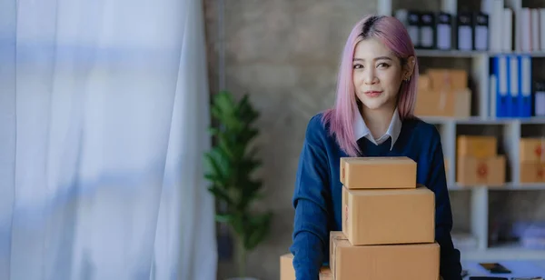 Asian woman preparing delivery boxes for online shopping Beginners start small business owners at home, SME business ideas like online shopping.