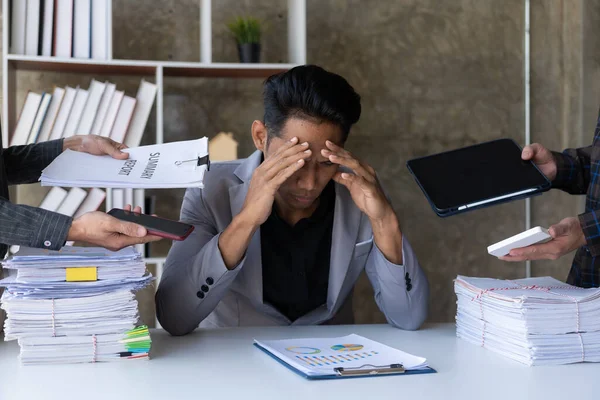 stock image Worried tired black businessman sitting at desk with pile of documents working on computer laptop looking sad and depressed in fatigue and overload.