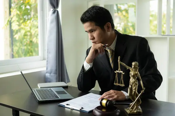lawyer, modern office, in formal attire. Golden scales law book, working on real estate and contract documents. Arguments for a defensive strategy fight for freedom