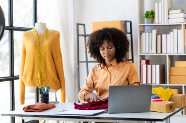 African American girls present and sell clothes online in live streaming. beautiful smiling female customers shopping in the internet choose stylish clothes fashion store,