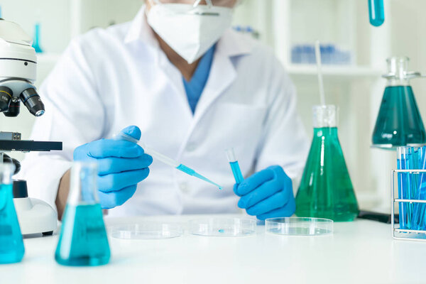 Medical Research Laboratory. Male scientist analyzing advanced science data for medical biotechnology development of microbiology laboratory researchers wearing gloves close-up image