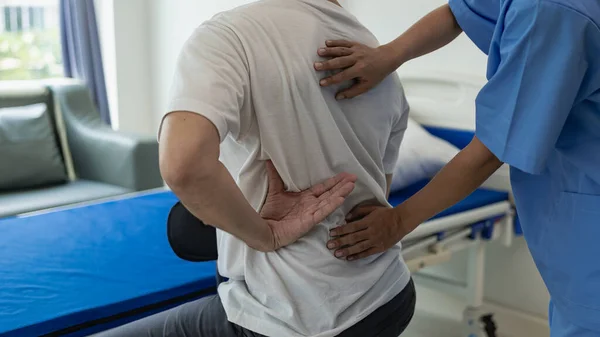 Doctors, physiotherapists treat patients with rehabilitation arm pain, do physiotherapy by treating his therapist in stretching in the clinic. Remote Picture