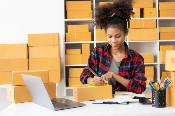 stock image Entrepreneurs working from home Online shopping, ecommerce, internet banking, spending money, work from home ideas with parcel boxesSME business ideas