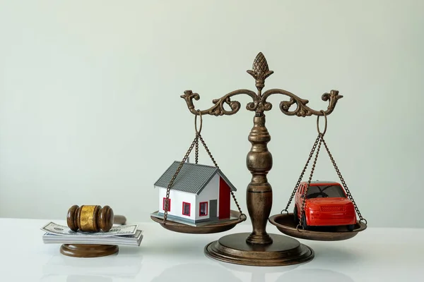 Property auction concept Cars and houses Judge\'s hammer and scales of justice, Gavel and miniature car on table