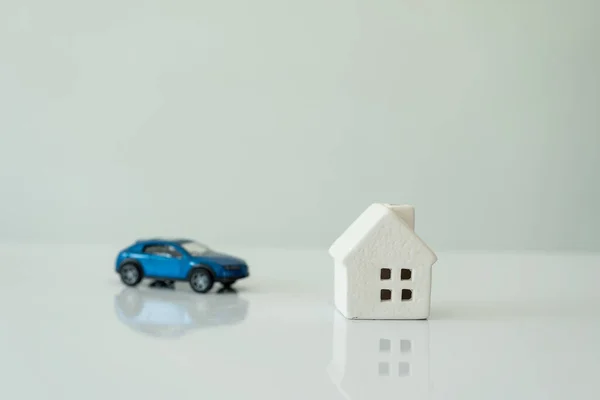 Car and house models, white background, insurance concept or real estate loan or property background Safety protection and health insurance family home concept