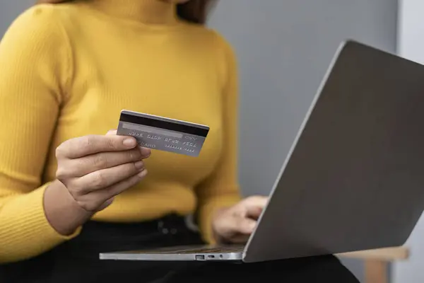 happy woman Credit card and phone and laptop on sofa, online shopping Ecommerce and payments made easy Asian man in China typing bank information