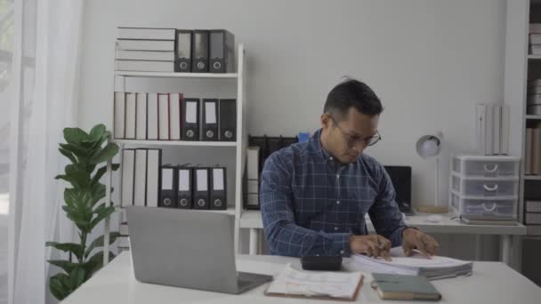 Серйозний Азіатський Бізнесмен Який Працює Папером Калькулятором Документів Фінансового Графіку — стокове відео