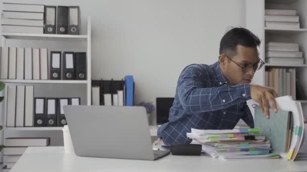 ストレスを受けたアジアのビジネスマンは 財務文書で作業し 疲労した従業員がオフィスで過負荷にさらされていることを強調しました — ストック動画