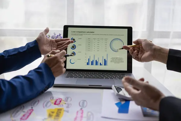 Businessman or accounting team analyzing graph data chart and laptop dashboard to prepare statistical reports and discuss financial data to analyze market data. Close-up image