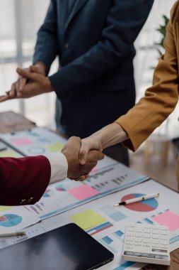 İki işadamı iş konusunda hemfikir ve başarılı müzakerelerden sonra el sıkışıyorlar. El sıkışmak bir selamlama ya da tebrik etme şeklidir. Yakın plan resimler.
