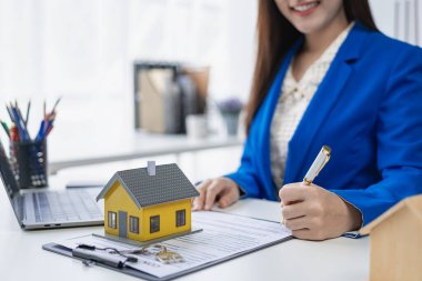 Asyalı kadın emlakçı müşteriye ev tanıtıyor, müşteriye ev ya da apartman dekorasyonunu açıklıyor, çevrimiçi ev satış danışmanı konsepti.