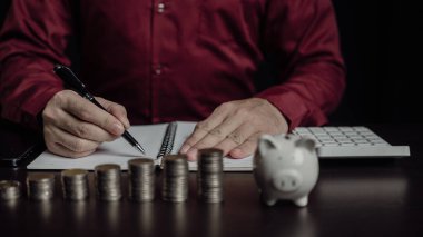 Emeklilik fonlarının gelecekteki finansal hazırlıkları için planlama Geleceğin Risk Yönetimi Tasarruf hesabı İnsan eli ahşap bir masada bir kumbara tutuyor Para ve finans kavramından tasarruf