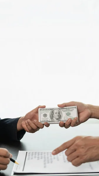 Government officials receive bribes from businessmen who have ideas about corruption and anti-bribery. Businessman\'s hand holding bribe to official signing contract for business project