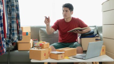 Çevrimiçi mağaza sahipleri müşterilerle siparişleri onaylamak ve paket kutularda taşımacılık için ürünleri paketlemek için İnternet sitelerinden gelen siparişleri kontrol ediyorlar. KOBİ konsepti çevrimiçi ürün satıyor