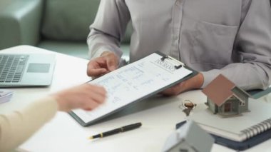 Bir satış temsilcisi ev ya da daire satın almak için ev satın alma sözleşmesi önerir. Ya da kredi faizi, sigorta müşterisi ve emlakçının ofiste el sıkışması hakkında konuşabilirsiniz.