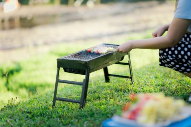 Barbecue Food in nature Cooking on the grill Picnic Holiday in nature Close-up of grilled medium-rare barbecue steak Food concept clipart