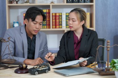 Avukatlar, minyatür arabaları açık artırma sembolü veya kaza sürücülerine karşı mahkeme işlemleri olan kadınlara tavsiyede bulunuyor ve masaya araba sigortası ödemeleri getiriliyor..