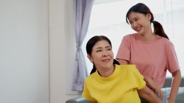 Rehabilitasyon yapan yaşlı bir kadın veya hastanın eklem ağrısı tedavisi, eklem iltihabı olan hastaya destek, genç kızın yardımıyla omuz hareketliliği testi