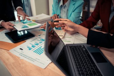 İş sunumları veya seminerler için toplantılarda bu tür belgeler mali veya pazarlama rakamları, grafikleri ve grafikleri içerir. Masada dizüstü bilgisayarlar ve dijital tabletler var..