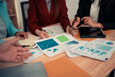 İş sunumları veya seminerler için toplantılarda bu tür belgeler mali veya pazarlama rakamları, grafikleri ve grafikleri içerir. Masada dizüstü bilgisayarlar ve dijital tabletler var..