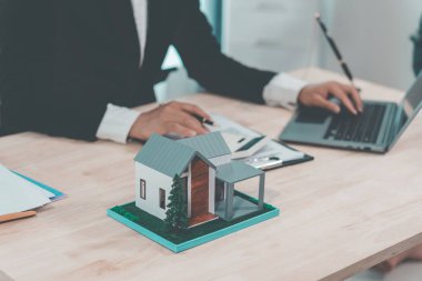 Real estate agent delivers model home to client, home insurance contract, home mortgage loan concept, real estate