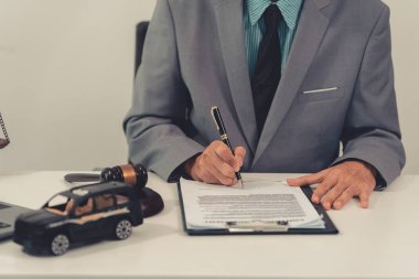 Toy cars on the table represent accident insurance, court proceedings, auctions, judge's gavel is a legal symbol of judgment, law, crime.