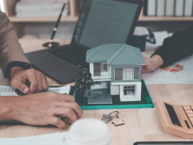 Real estate agent delivers model home to client, home insurance contract, home mortgage loan concept, real estate